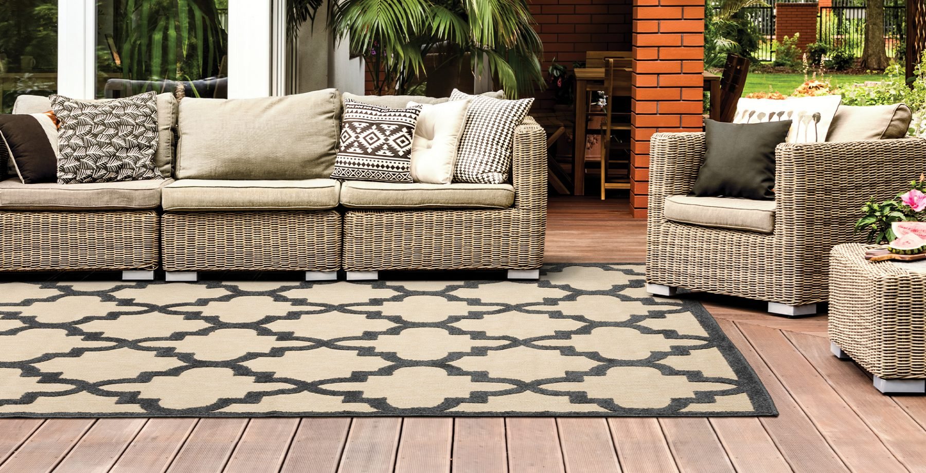 beige exterior couches on a terrace and area rug from Henson's Greater Tennessee Flooring in Knoxville TN