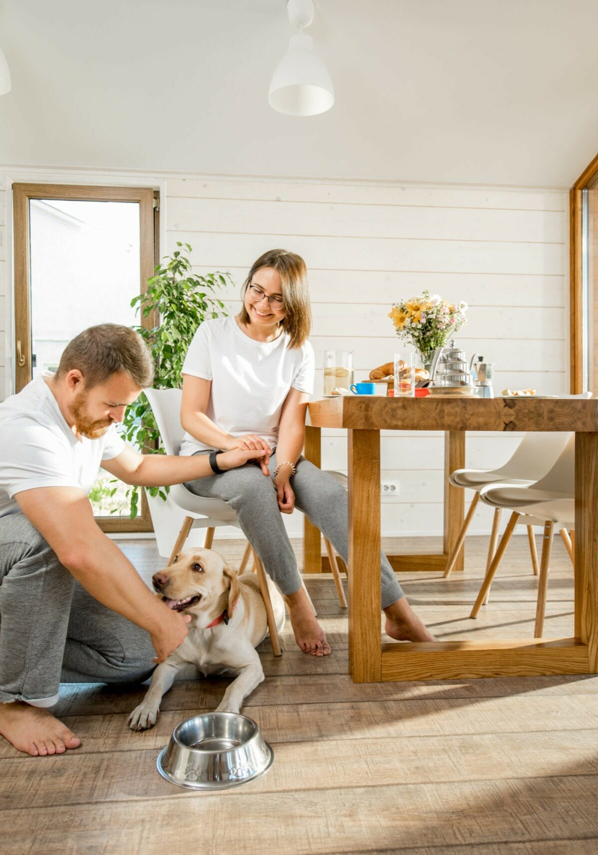 Young couple with dog at home | Henson's Greater Tennessee Flooring