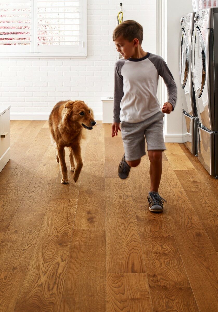 Dog running with kid | Henson's Greater Tennessee Flooring